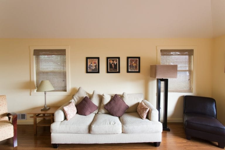 Living room at Rosie's Cottage with couch and hard wood floors